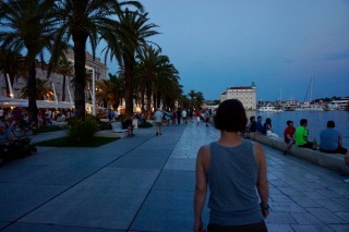 She walks, we follow. The Riva at dusk.
