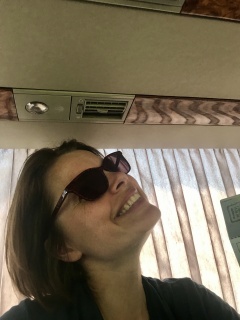 Holding her humor together on the bus.