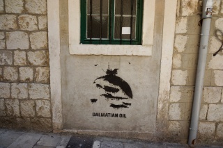 A stenciled dolphin selling Dalmatian oil. We had questions.