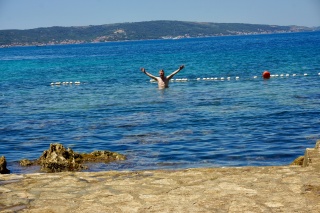 Theresa, arms up, mid-swim. Earned.
