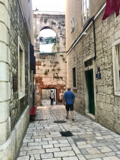 Up a narrow lane toward the arch. Our kind of street.