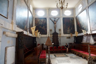 The choir, all dark wood and dim paintings.