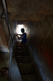 Somebody silhouetted on a dark stair.