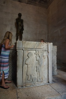 Theresa reading the tomb. Brian peering over it.