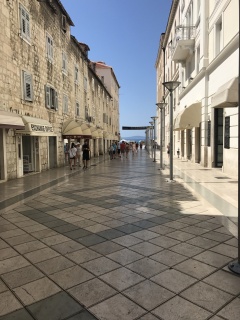 Down the polished stone toward the water.