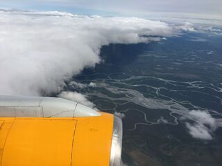 Braided rivers and the last of the clouds. Alaska under there somewhere.