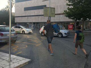 Crossing the street with our whole lives on our backs.