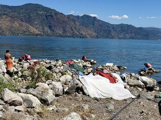 Laundry services doing washing in the lake