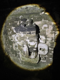 By flashlight, a very large Mayan mask